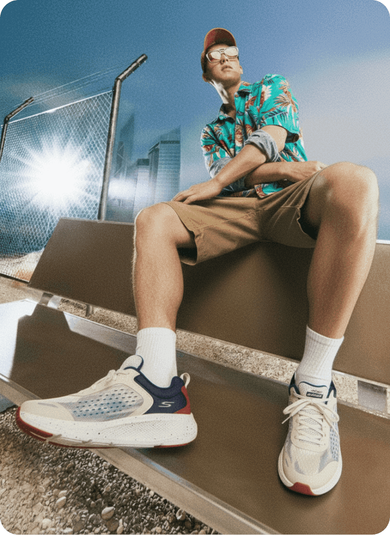 Man seated outdoors in a bright lifestyle scene