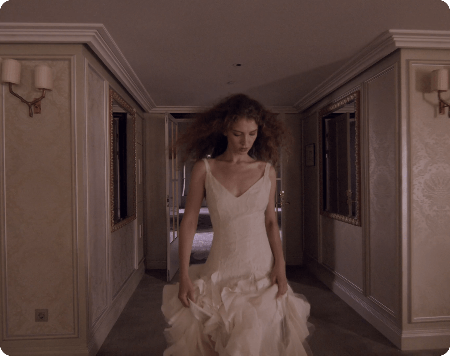 Woman in a white dress in a corridor editorial scene